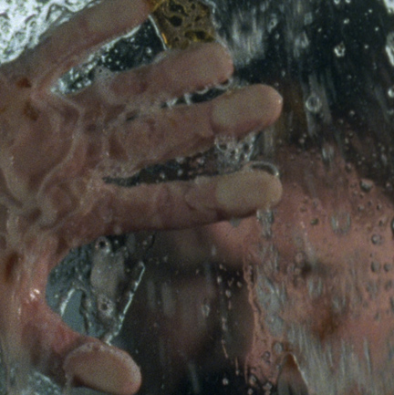 hand placed on window, water on window